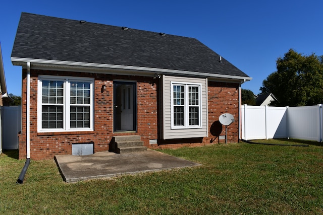 back of house with a yard