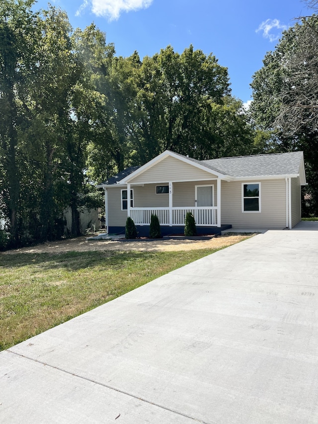 ranch-style home with a porch and a front yard