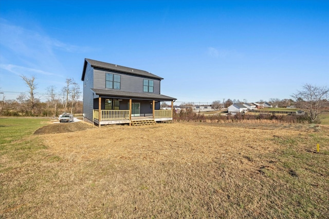 back of house with a porch and a lawn