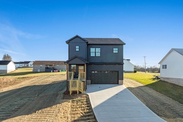 modern inspired farmhouse with a front yard and a garage