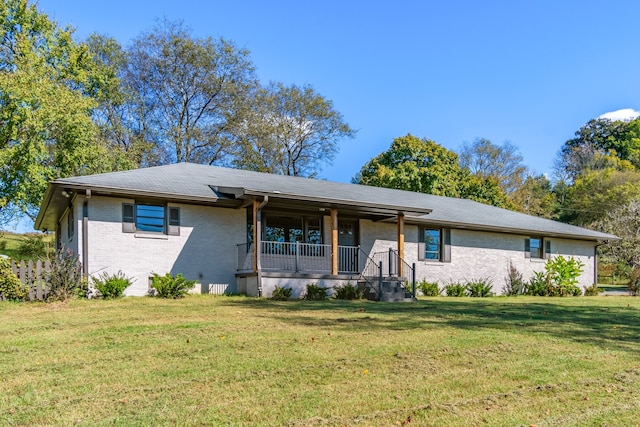 single story home with covered porch and a front lawn