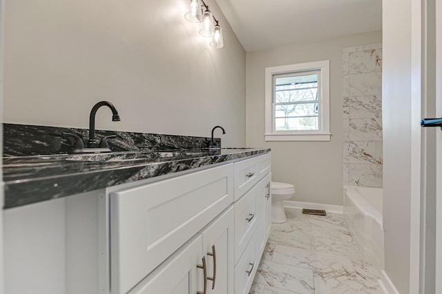 bathroom featuring vanity, toilet, and a bathing tub