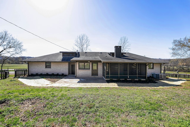 back of property featuring a yard, cooling unit, and a sunroom