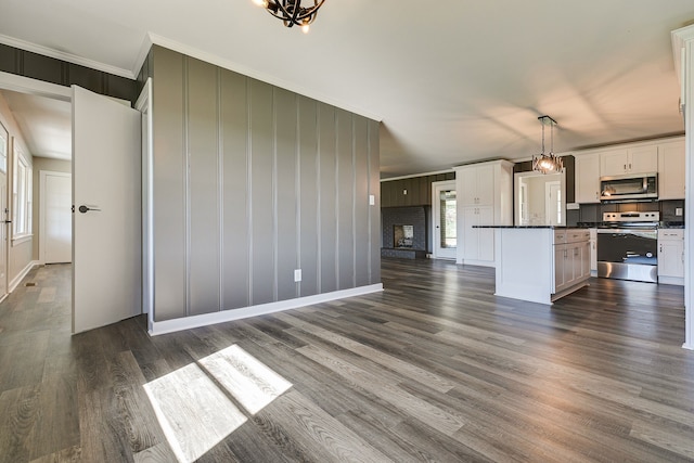 kitchen featuring white cabinets, hanging light fixtures, a kitchen island, dark hardwood / wood-style floors, and stainless steel appliances