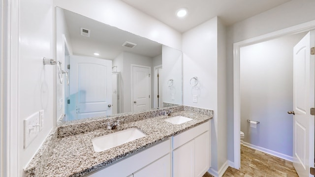 bathroom with toilet, a tub, and vanity