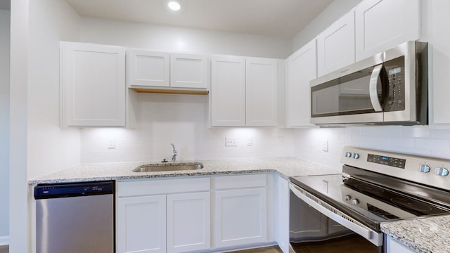 kitchen with sink, white cabinetry, and stainless steel appliances