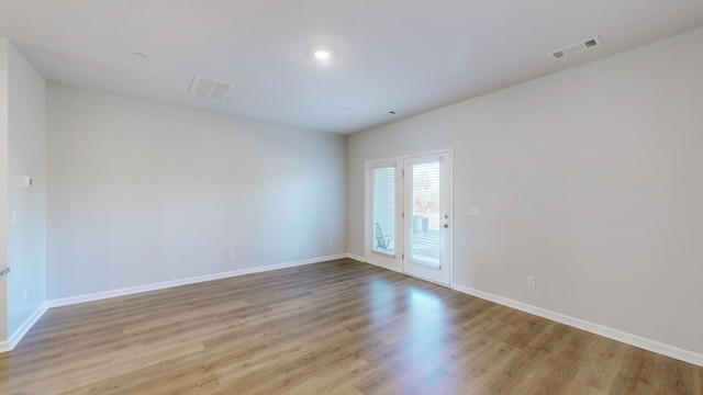 unfurnished room with light wood-type flooring