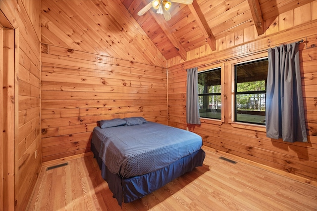 bedroom with access to outside, light hardwood / wood-style flooring, vaulted ceiling with beams, and wooden walls