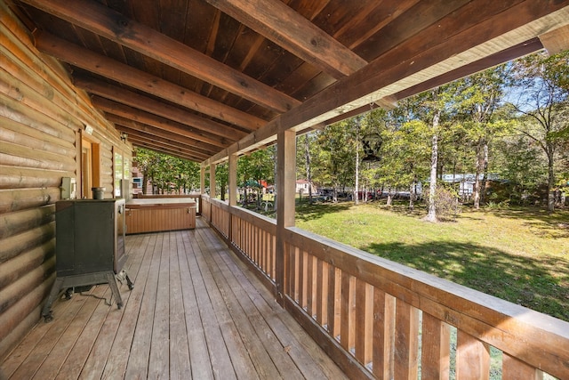 wooden terrace featuring a yard