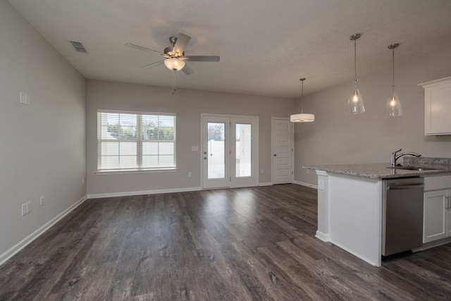 kitchen featuring sink, light stone countertops, stainless steel dishwasher, white cabinets, and dark hardwood / wood-style flooring