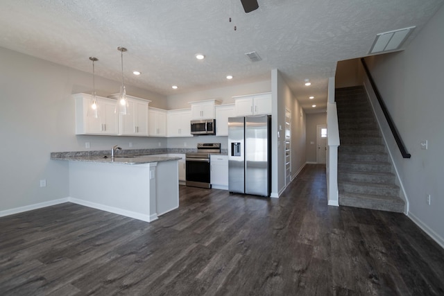 kitchen with dark hardwood / wood-style floors, hanging light fixtures, kitchen peninsula, stainless steel appliances, and white cabinets