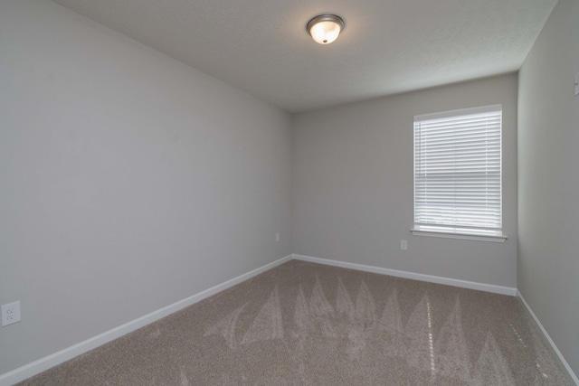 unfurnished room featuring carpet flooring