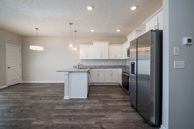 kitchen featuring light stone countertops, appliances with stainless steel finishes, dark hardwood / wood-style flooring, white cabinetry, and decorative light fixtures