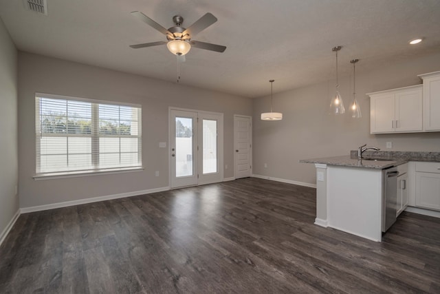 kitchen with white cabinets, light stone countertops, dishwasher, dark hardwood / wood-style floors, and sink