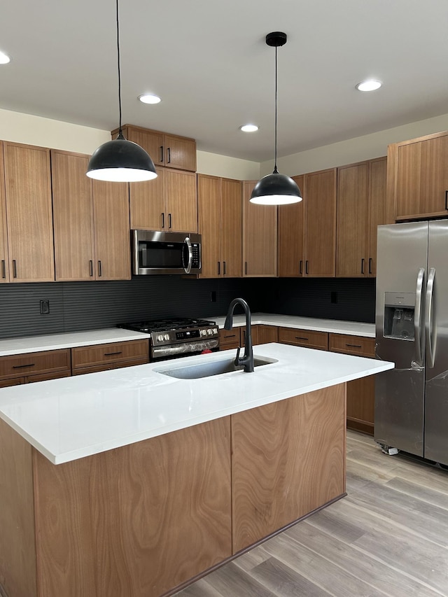 kitchen featuring pendant lighting, stainless steel appliances, tasteful backsplash, and sink