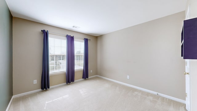 empty room with light colored carpet