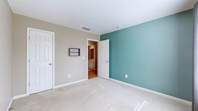 unfurnished bedroom featuring light carpet