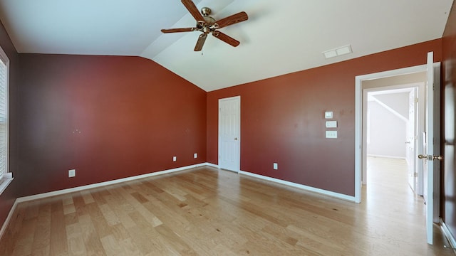 spare room with ceiling fan, lofted ceiling, and light hardwood / wood-style flooring