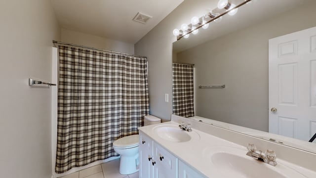 bathroom with vanity, toilet, curtained shower, and tile patterned flooring