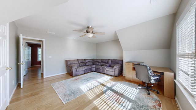 office area featuring light hardwood / wood-style floors, lofted ceiling, and ceiling fan