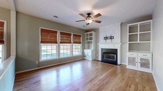 unfurnished living room with light hardwood / wood-style floors and ceiling fan