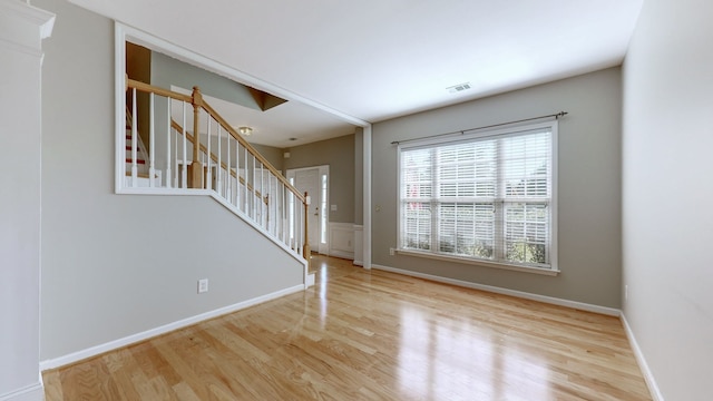 empty room with light hardwood / wood-style flooring