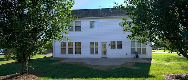 back of house featuring a patio and a lawn