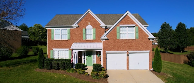 view of front of house with a front yard and a garage