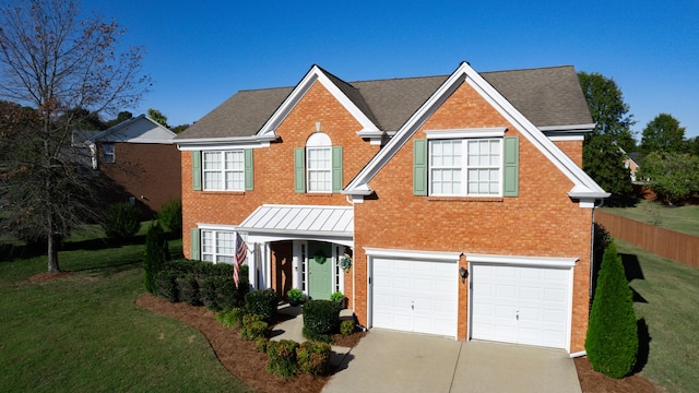 front facade with a front yard and a garage