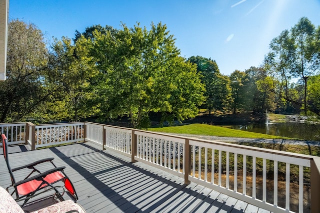 wooden terrace featuring a water view