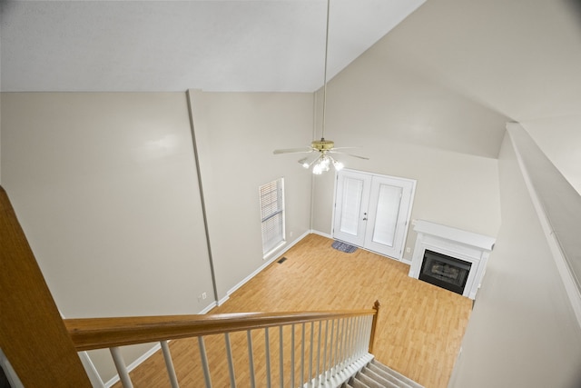 interior space featuring high vaulted ceiling, hardwood / wood-style flooring, and ceiling fan