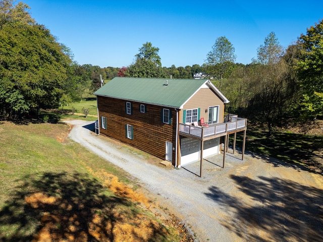 view of front facade featuring a wooden deck and a garage