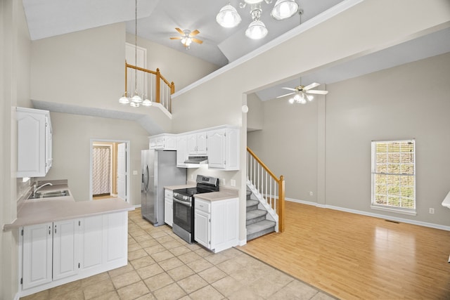 kitchen with light hardwood / wood-style flooring, stainless steel appliances, decorative light fixtures, white cabinets, and ceiling fan