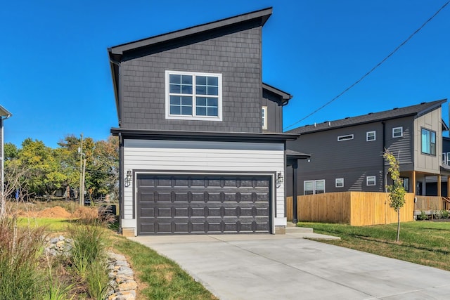 front facade featuring a front lawn and a garage