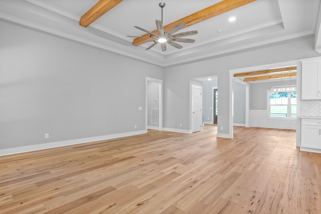 unfurnished living room with beam ceiling, a raised ceiling, light wood-type flooring, ornamental molding, and ceiling fan with notable chandelier