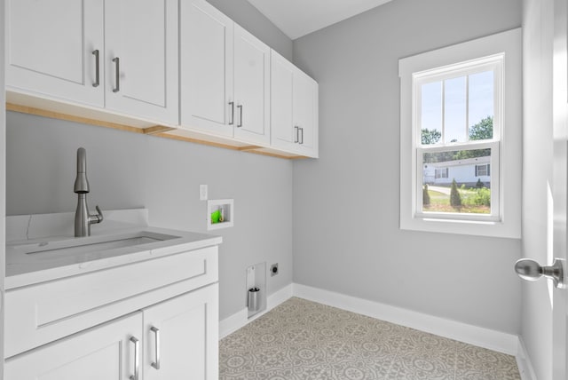 laundry area featuring hookup for an electric dryer, sink, washer hookup, and cabinets