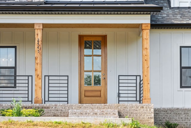 view of exterior entry with a porch