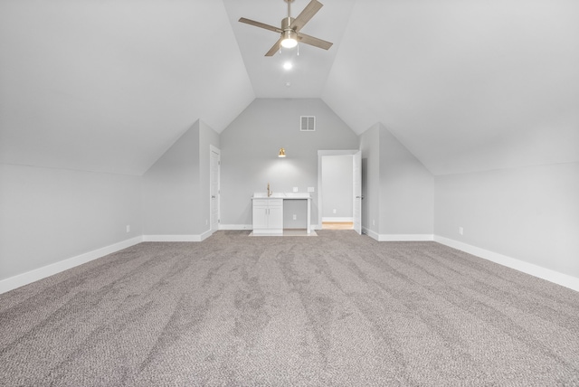 additional living space with ceiling fan, vaulted ceiling, and carpet floors