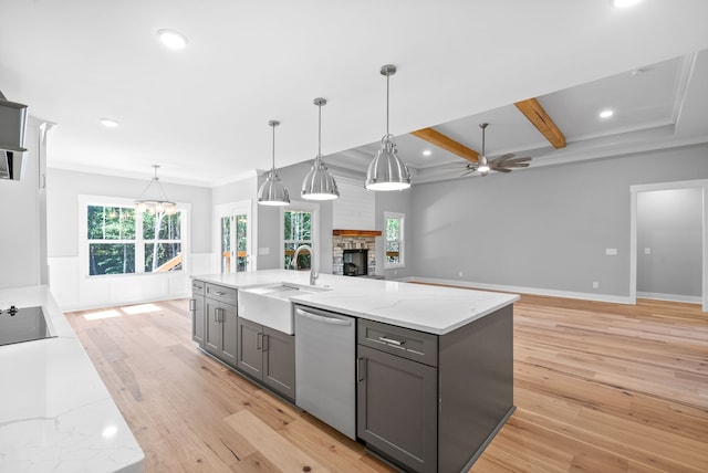 kitchen with a kitchen island with sink, dishwasher, beamed ceiling, light hardwood / wood-style floors, and sink