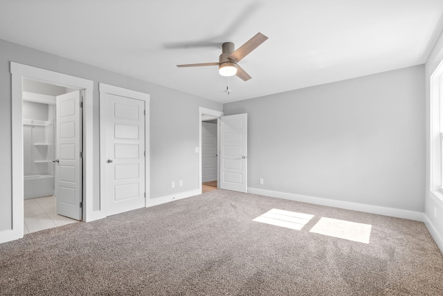 unfurnished bedroom with ceiling fan and light carpet