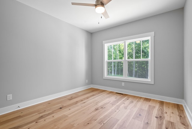 spare room featuring light hardwood / wood-style flooring and ceiling fan