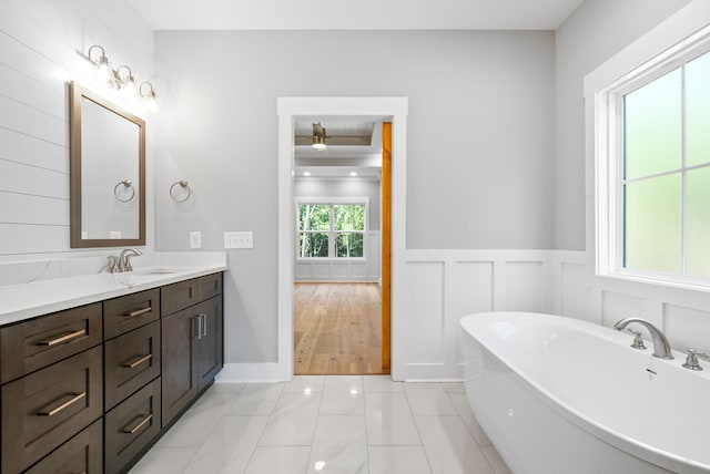 bathroom with vanity, a bathing tub, and hardwood / wood-style floors