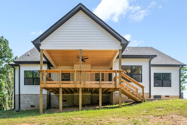 back of property with a deck and ceiling fan