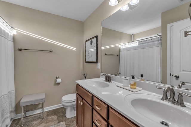 bathroom featuring toilet, vanity, and a shower with shower curtain