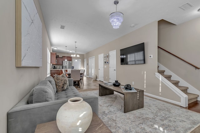 living room with a notable chandelier and hardwood / wood-style flooring