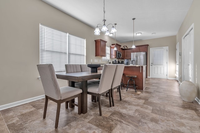 dining space with an inviting chandelier