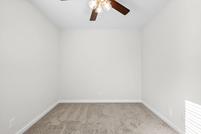 spare room featuring light carpet and ceiling fan