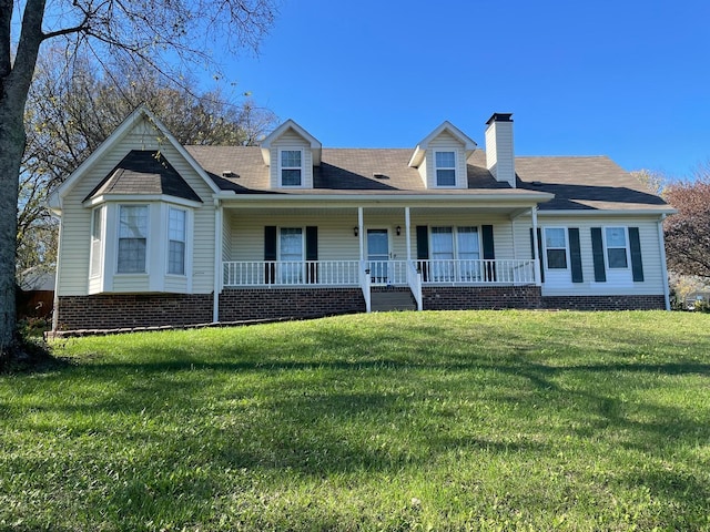 cape cod house with covered porch and a front lawn