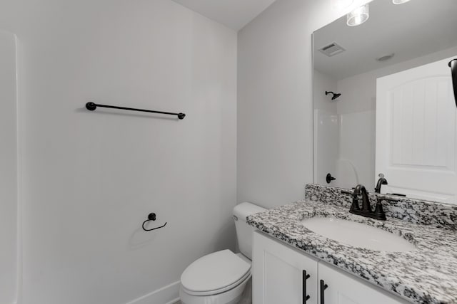 bathroom with vanity, toilet, and walk in shower