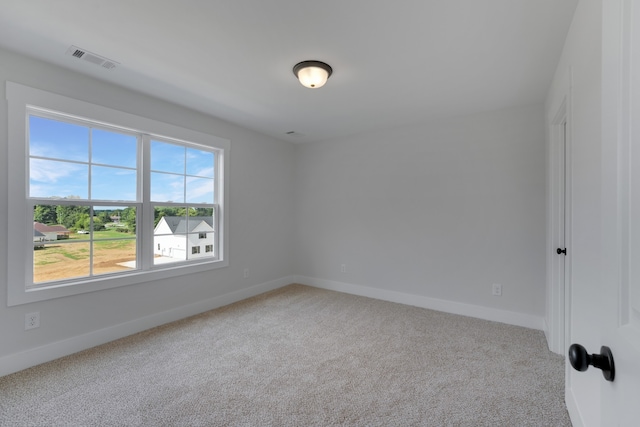 spare room with light colored carpet